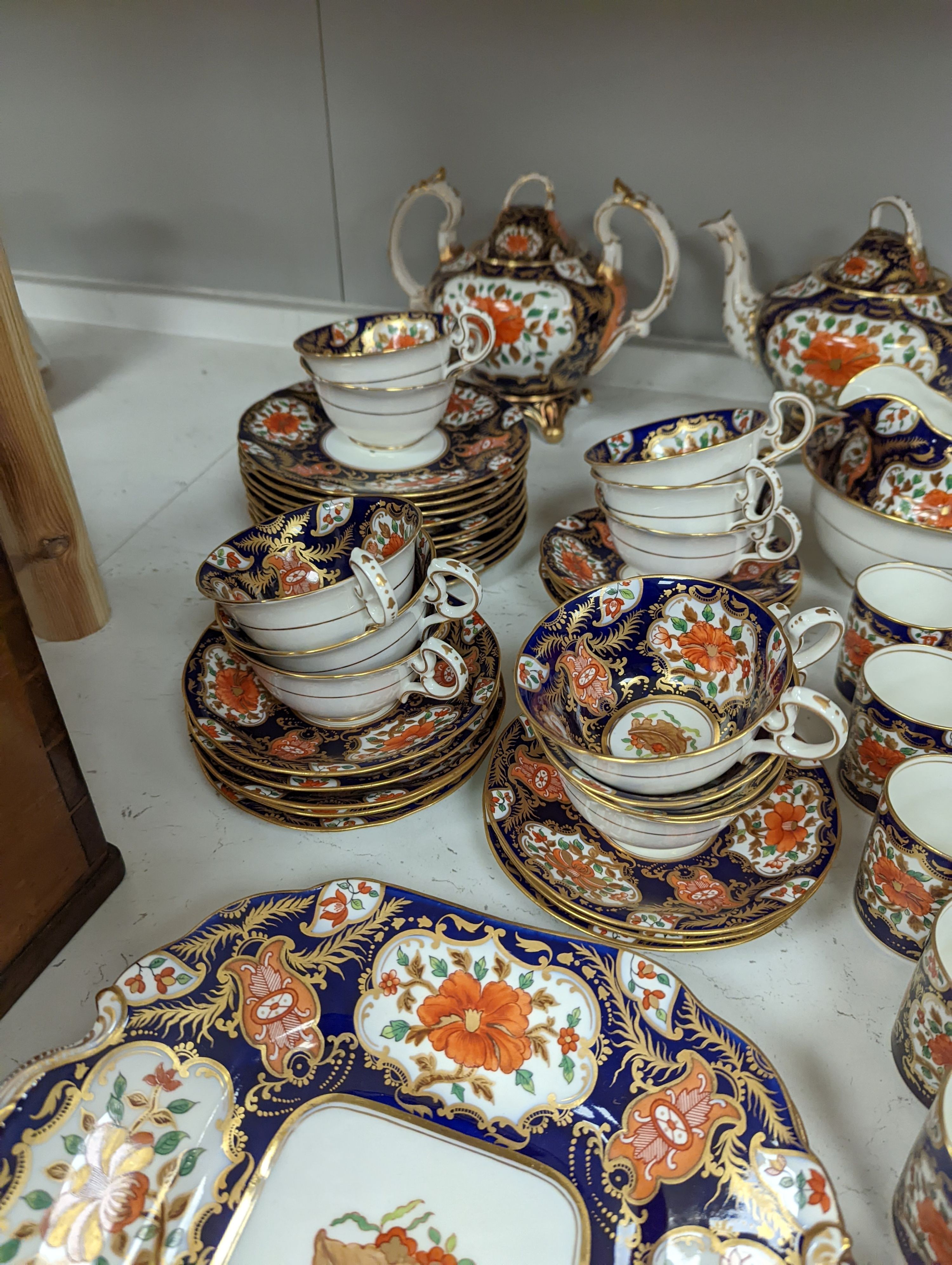 A mid 19th century English bone china fifty-two piece part tea and coffee service, decorated in an Imari pattern